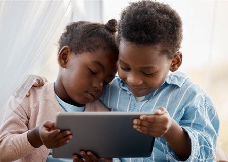 Screen time is meant to be shared. Shot of a little boy and girl watching something together on a digital tablet.の写真素材