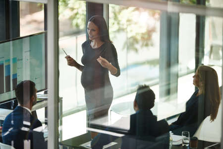 Taking stock and setting new targets. Shot of a corporate businessperson giving a presentation in the boardroom.の写真素材