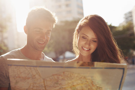 Finding their way around on vacation. Cropped shot of a young couple touring a foreign city.の写真素材