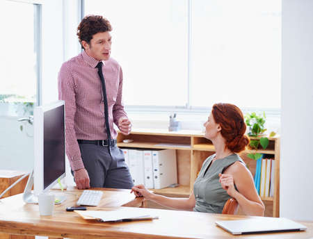 Making sure theyre on the same page. Shot of two businesspeople having a discussion in the office.