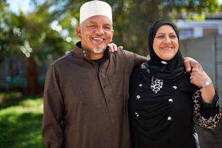 Living life with love. Portrait of a smiling senior muslim couple outside.の写真素材