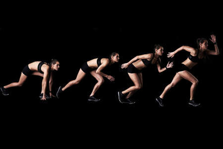 And shes off. Studio shot of a woman working out against a dark background.の写真素材