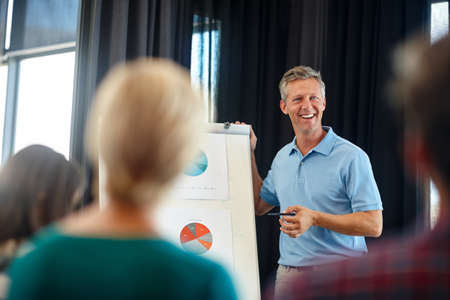 Without you none of this would be possible. Shot of a mature man doing a presentation for his...