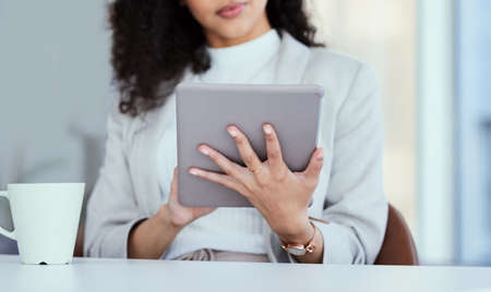 I love reading on my tablet. Shot of a businesswoman using her digital tablet.