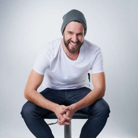 Cheerful and confident. Portrait of a happy young man posing against a white background in studio.の写真素材