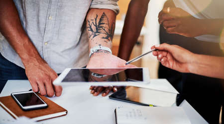 Planning is just the beginning. Cropped shot of a group of creative business colleagues meeting in the boardroom.の写真素材