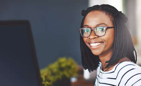 Im here to make a success of my career. Portrait of a young businesswoman working on a computer in an office.の写真素材