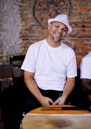 Looking relaxed. Cropped shot of a young ethnic man seated indoors.の写真素材