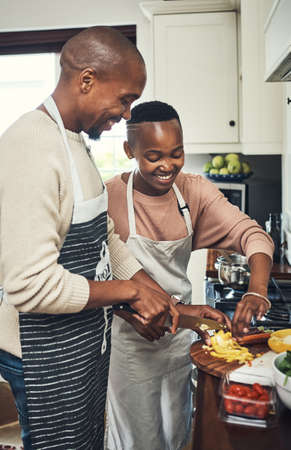 They love cooking together. Cropped shot of an affectionate young couple preparing dinner in their...