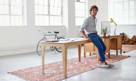 He takes pride in his work. Full length portrait of a handsome male designer in his modern office.