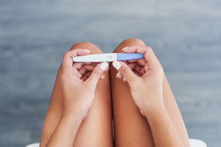 Is it the result you wanted. Cropped shot of an unrecognizable woman taking a pregnancy test at...