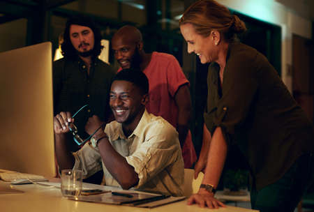 Great things happen when a team works together. Shot of a group of businesspeople looking at...