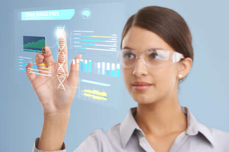DNA analysis in progress.... Shot of a female scientist using a digital interface to do a DNA...