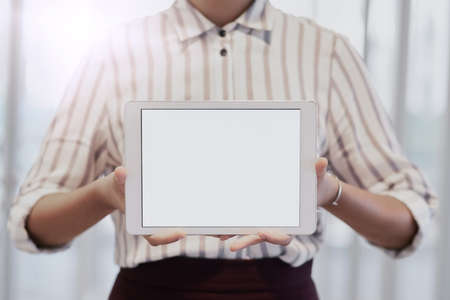 Use this space to your brands advantage. Closeup shot of an unrecognizable businesswoman holding up a digital tablet with a blank screen in an office.の写真素材
