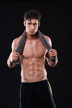 ABsolute discipline. Studio shot of a muscular bare-chested young man isolated on black.