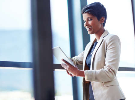 4g technology gives her the corporate advantage. Shot of a young businesswoman using a digital...