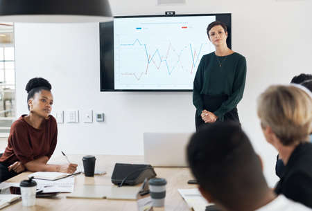 The monthly management meeting is in session. Shot of a group of businesspeople having a meeting in a modern office.の写真素材