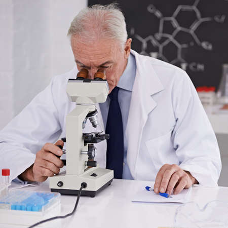 Breaking discoveries in the lab. Shot of a mature scientist using a microscope.
