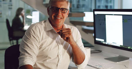 I couldnt see myself working anywhere else. Cropped portrait of a mature businessman sitting at his...