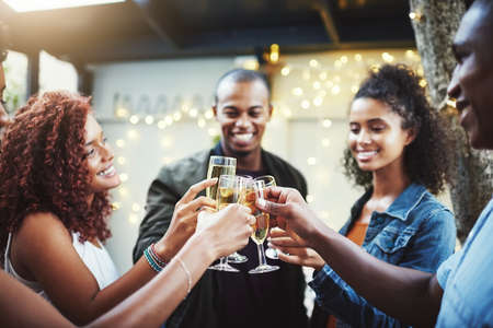 Cheers to a good night ahead. Shot of a group of young friends making a toast.