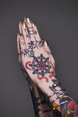 Creative self-expression. A cropped shot of tattooed hands.の写真素材