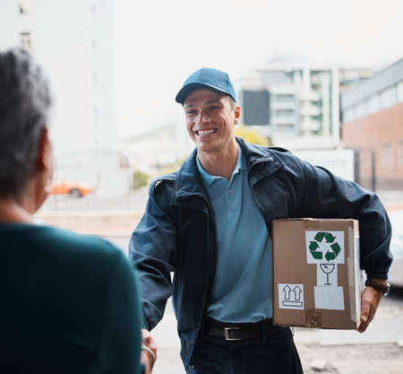 Always delivering goods with a smile. Cropped shot of a handsome young man delivering a package to a...