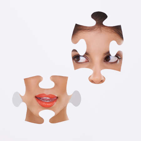 She puts it together. Shot of a beautiful young woman through a cut out shape.の写真素材