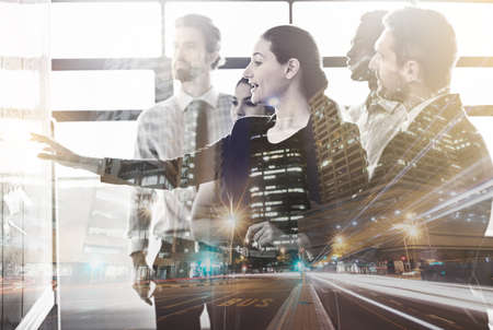Taking their city to new heights. Multiple exposure shot of a group of colleagues superimposed over...