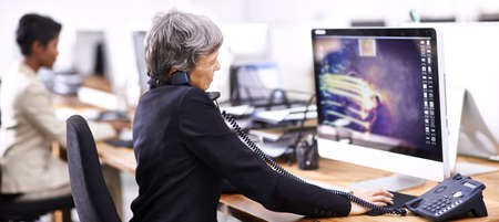 Just another busy day in the office. Cropped shot of two businesswomen working in an office.の写真素材