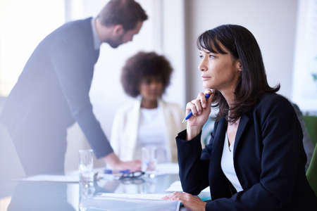 Getting the job done with teamwork. Cropped shot of a group of business colleagues meeting in the...