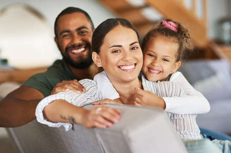 We love our cosy days at home. Portrait of a happy family relaxing together at home.
