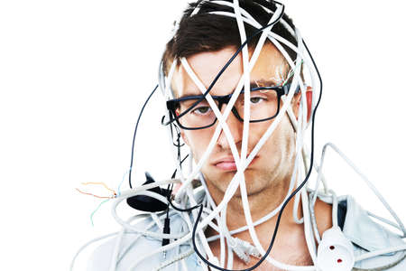 This is not going well. Studio portrait of a young man with cables hanging over his head isolated on white.の写真素材