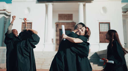 The tests are over, your grades are in, and its time to celebrate. Shot of students hugging and celebrating on graduation day.の写真素材