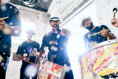 Youve got some moves. Low angle portrait of a group of handsome young male drummers playing at...