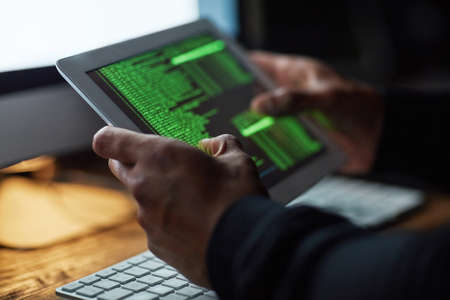 No system is uncrackable. Cropped shot of an unidentifiable hacker cracking a computer code in the...