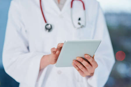 The medical records of every patient in one place. Cropped shot of an unrecognizable female doctor...