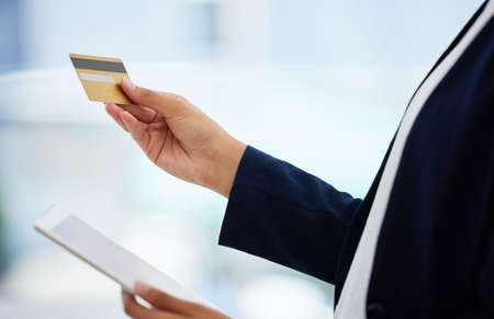 The digital age has made online shopping so easy. Shot of an unrecognizable person using their...