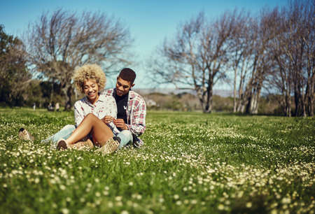This is our favorite spot. Shot of a young couple spending quality time together at the park.