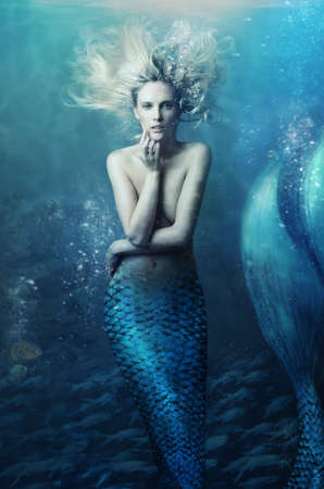 Shot of a mermaid swimming in solitude in the deep blue sea - ALL design on this image is created from scratch by Yuri Arcurs team of professionals for this particular photo shootの写真素材