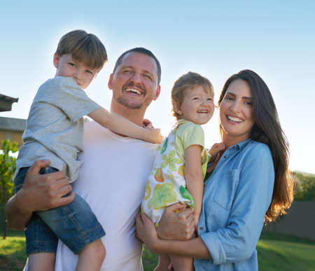 Theyre our greatest source of joy. Portrait of a happy family bonding together outdoors.
