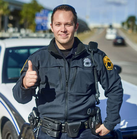 This city is safe. Cropped portrait of a handsome young policeman giving thumbs up while out on...