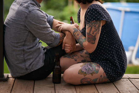Tattoos are what feelings look like. Cropped shot of a tattooed hanging out together on the porch.の写真素材