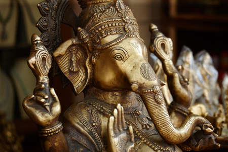 Beautifully crafted iconography. Closeup of a bronze effigy of the god Ganesha in an Indian temple.の写真素材