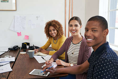 Time to be productive. Shot of a group of colleagues having a meeting in a modern office.