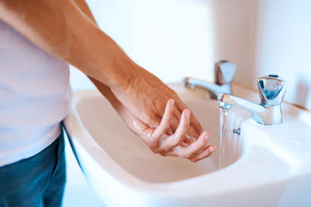 Stay safe from germs by washing your hands regularly. Closeup shot of an unrecognizable man washing...