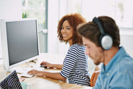 Weve got a great office vibe. Cropped shot of two colleagues working in their office.