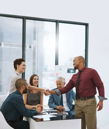 Its great to finally meet you. Shot of two businesspeople shaking hands during a meeting in the...