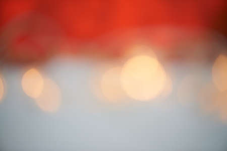 Bright lights, beautiful holiday. Bokeh lights against a red and grey background.の写真素材