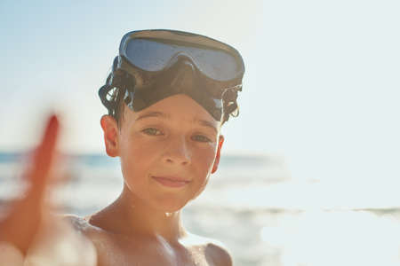 Ready to explore ocean. Cropped shot of a young boy enjoying a day at the beach.の写真素材
