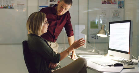 Two heads are always better than one. Cropped shot of two businesspeople working together on a...